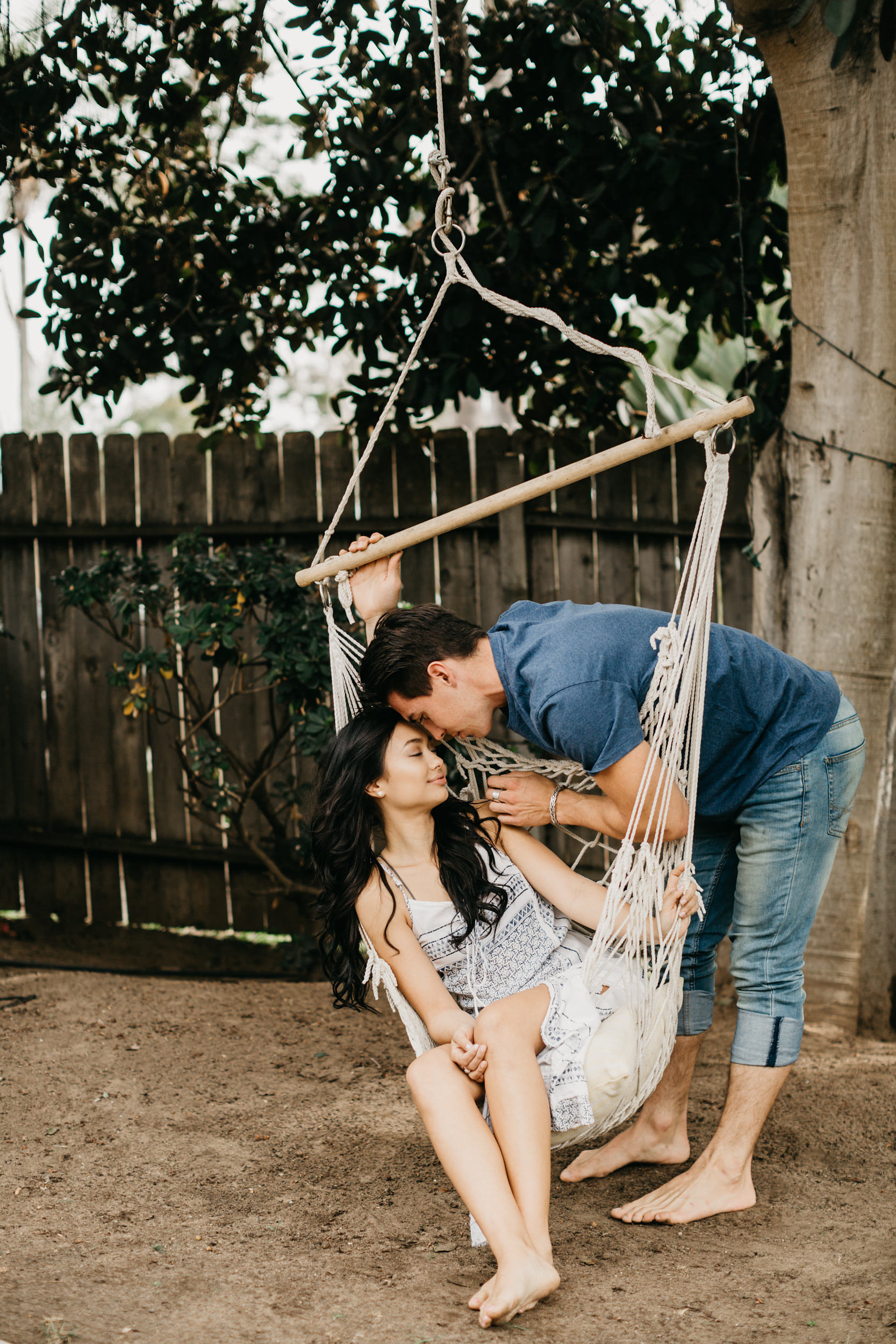 couple in yard on patio swing 