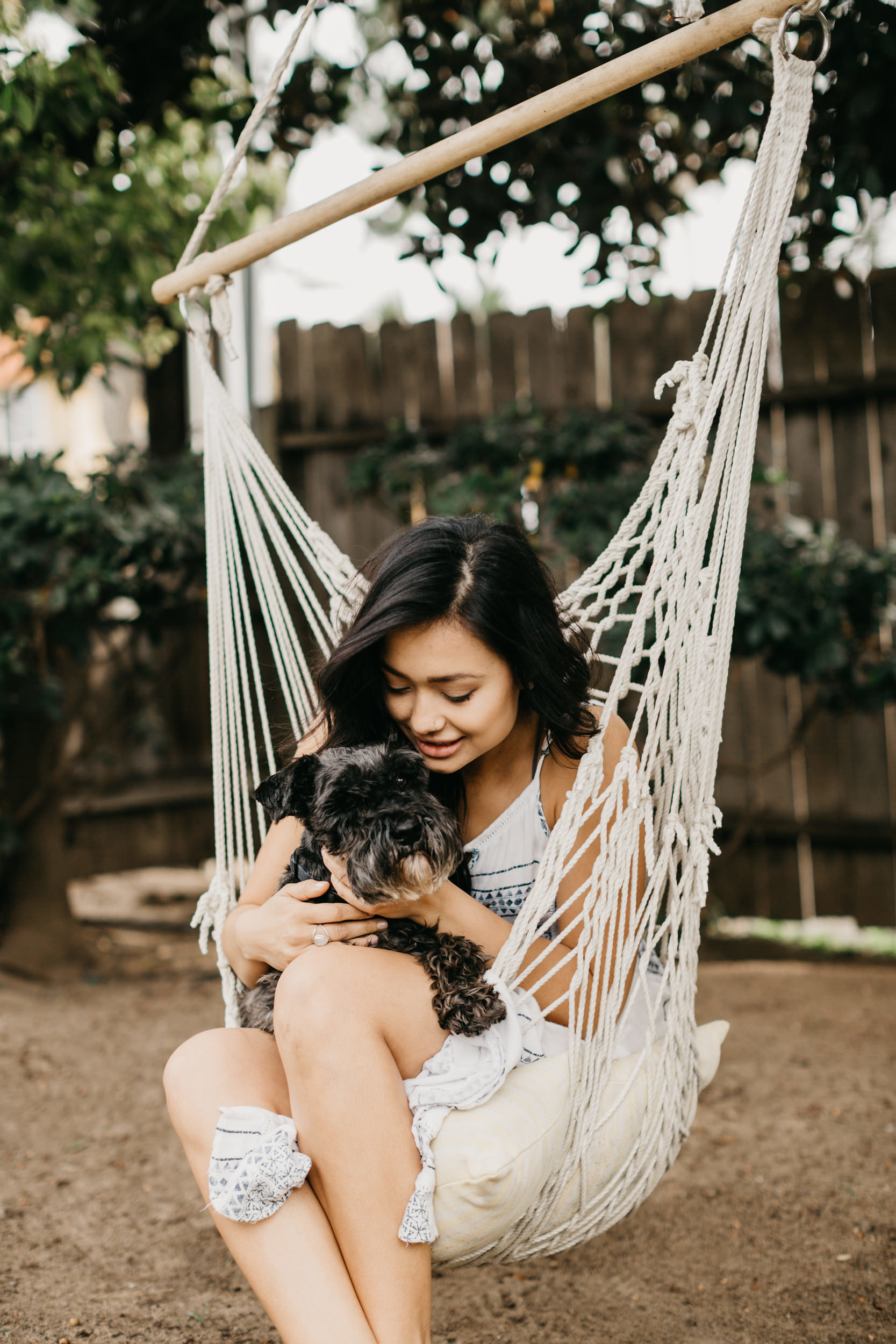 girl and dog on patio swing 