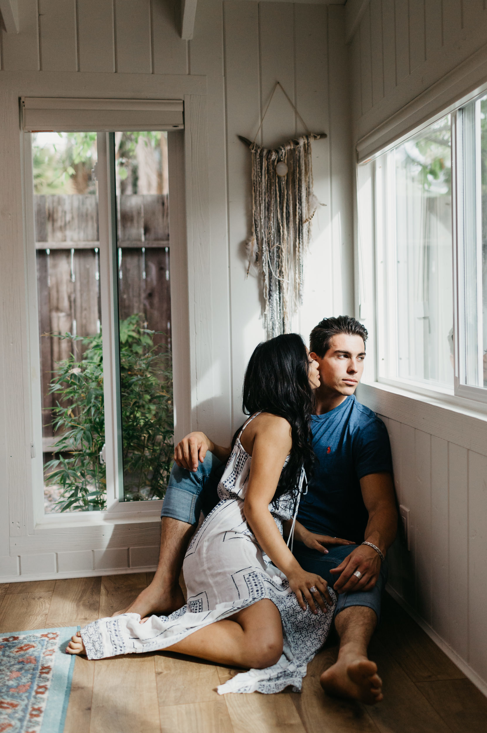 couple by window kissing 