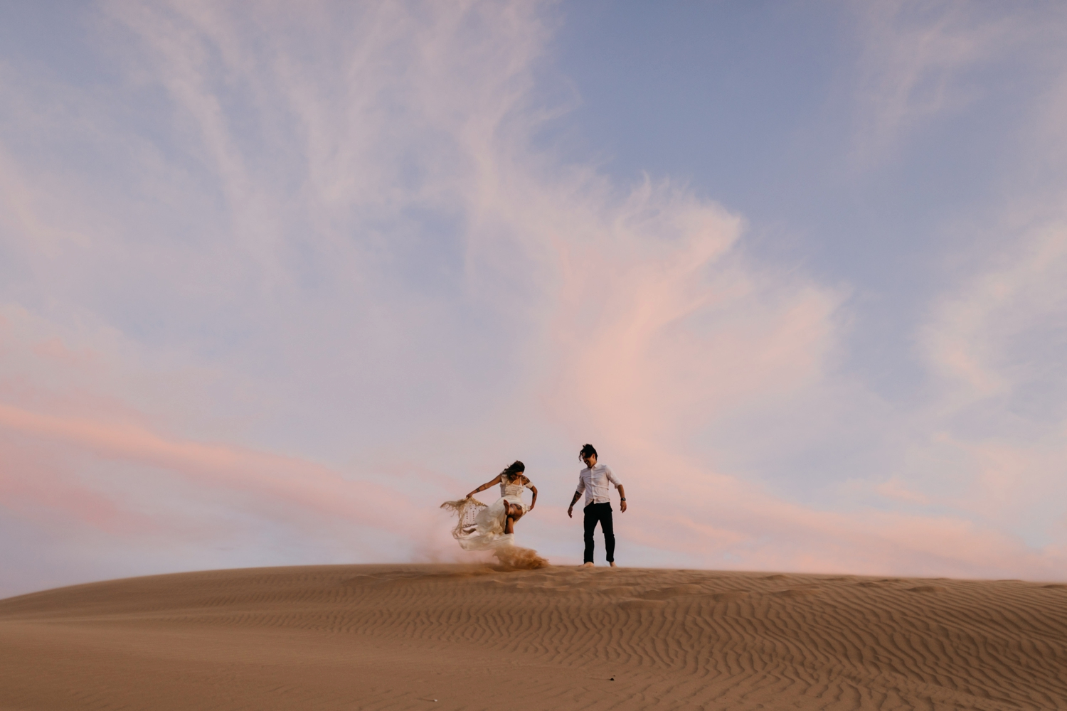 bride and groom in sand dunes 